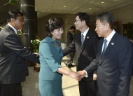 In this photo released by the South Korean Unification Ministry, the head of North Korea's delegation Kim Song Hye, center, shakes hands with South Korean delegate Kwon Young-yang, right, as South Korea's Unification Policy Officer Chun Hae-sung, second from right, shakes hands with an unidentified North Korean officer, left, upon their arrival for a meeting at the southern side of Panmunjom, which has separated the two Koreas since the Korean War, in Paju, north of Seoul, South Korea, Sunday, June 9, 2013. Government delegates from North and South Korea began preparatory talks Sunday at the "truce village" on their heavily armed border aimed at setting ground rules for a higher-level discussion on easing animosity and restoring stalled rapprochement projects.(AP Photo/South Korean Unification Ministry)