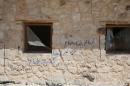 Graffiti reading in Arabic, "we came to you with hungry lions, to your flesh", at the devastated monastery of Syriac Catholic Saint Elian, in the town of al-Qaryatain, one of the last Islamic State (IS) group strongholds in central Syria