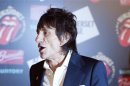 Ronnie Wood of the The Rolling Stones walks away after posing at the opening of the exhibition "Rolling Stones: 50" at Somerset House in London