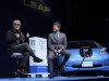 In this Sunday, March 18, 2012 photo, Japanese composer Ryuichi Sakamoto, left, speaks as Nissan Motor Co's Corporate Vice President Hideaki Watanabe listens, in front of the automaker's Leaf zero-emission electric vehicle at 'The New Owner's Meeting' in Tokyo.  Electric car owners who prided themselves on being green now find themselves in a bind as Japan's government maneuvers to restart dozens of nuclear power plants idled after last year's meltdowns.(AP Photo/Itsuo Inouye)