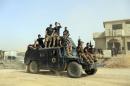 FILE -- In this Saturday, Oct. 15, 2016, file photo, Iraq's elite counterterrorism forces gather ahead of an operation to re-take the Islamic State-held City of Mosul, outside Irbil, Iraq. Iraqi forces appear poised to launch their most complex anti-IS operation to date: retaking the country's second largest city of Mosul. While the country's military has won a string of territorial victories that have pushed IS out of more than half of the territory the group once held, some Iraqi officials worry that the Mosul fight has been rushed and if the city is retaken without a plan to broker a peace, it could lead to more violence. (AP Photo/Khalid Mohammed, File)
