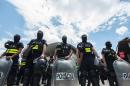 Costa Rican police personnel in riot gear form a line in the border with Panama, 320 km south of San Jose on April 14, 2016