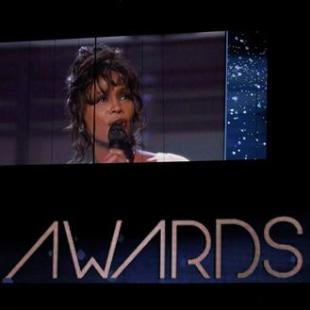 Singer Whitney Houston is shown on a video screen in a 1994 Grammy performance during the 54th annual Grammy Awards in Los Angeles