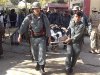 Afghan policemen carry the body of a civilian after a bomb blast in Faryab province