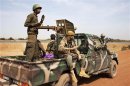 Malian soldiers ride in a Malian army pickup truck in Diabaly