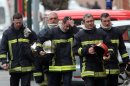 French firefighters leave after a police assault on a suspected Islamic extremist holed up in an apartment in Toulouse, southwestern France, Thursday, March 22, 2012. Mohamed Merah, who boasted of killing seven people to strike back at France died Thursday after jumping from his window, gun in hand, in a fierce shootout with police, a French minister said.. (AP Photo/Bob Edme)