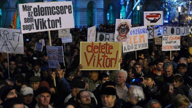 Protesters on November 17, 2014 holding placards reading &quot;Delete Viktor&quot; during a rally to mark what organizers called a &quot;Day of Indignation&quot; in front of the parliament building in Budapest