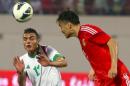 Ahmed Yaseen Gheni (L) of Iraq vies for the ball against Feng Xiaoting of China during their match in Sharjah, on March 5, 2014