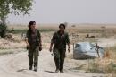 Kurdish female fighters from the People's Protection Units (YPG), operating alongside with the Syria Democratic Forces, walk in northern province of Raqqa