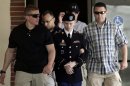 U.S. Army Private First Class Bradley Manning is escorted from the courtroom after a day of his court martial trial at Fort Meade, Maryland