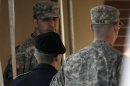 Army Pfc. Bradley Manning, center, is escorted by a security detail into a courthouse in Fort Meade, Md., Thursday, March 15, 2012. Manning, a US Army private accused of leaking classified material to the anti-secrecy website Wikileaks could soon learn when his trial will start. (AP Photo/Cliff Owen)
