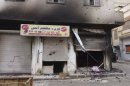 Damaged building is seen at Karm al-Zeitoun near Homs