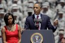 First lady Michelle Obama listens as President Barack Obama speaks to soldiers at the Fort Stewart Army post, Friday, April 27, 2012, in Fort Stewart, Ga. (AP Photo/David Goldman)