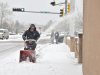 Sidewalks get cleared along the Paseo de Peralta in Santa Fe, N.M. as Santa Fe residents deal with the winter storm that hit Monday Dec. 19, 2011.  New Mexico state police say a winter storm is shutting highways and causing difficult driving across northern New Mexico. Los Alamos National Laboratory and a number of schools have closed as the storm moves across New Mexico and into the Texas and Oklahoma Panhandles and parts of Kansas and Colorado.   (AP Photo/The New Mexican, Clyde Mueller)
