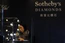 A member of staff checks a display prior to the exhibition sale of Sotheby's Diamonds during Sotheby's Beijing Art Week in Beijing