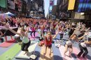 People practice yoga in New York's Times Square, Friday, June 21, 2013. Yoga enthusiast marked the longest day of the year with five free "Mind Over Madness" yoga classes during the11th annual Solstice in Times Square. (AP Photo/Mary Altaffer)