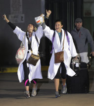 Kendall Jenkins, left, of Houston, celebrates with Brittany Ferguson, of Houston, after getting off the Carnival Triump in Mobile, Ala., Thursday, Feb. 14, 2013. The ship with more than 4,200 passengers and crew members has been idled for nearly a week in the Gulf of Mexico following an engine room fire. (AP Photo/John David Mercer)