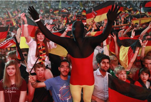Fans watch the Euro 2012 semi-final soccer match between Germany and Italy during a public screening in Frankfurt
