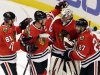 Chicago Blackhawks goalie Ray Emery, second from right, celebrates with Jonathan Toews (19), Marian Hossa (81) and Johnny Oduya (27) after the Blackhawks defeated the San Jose Sharks 2-1 during an NHL hockey game in Chicago, Friday, Feb. 22, 2013. (AP Photo/Nam Y. Huh)