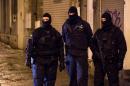 Belgian police officers guard a street in Verviers, Belgium, Thursday, Jan. 15, 2015. Belgian authorities say two people have been killed and one has been arrested during a shootout in an anti-terrorist operation in the eastern city of Verviers. (AP Photo/Geert Vanden Wijngaert)
