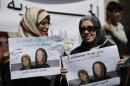 Women hold posters of Frenchwoman, Isabelle Prime (R) and her Yemeni translator Shereen Makawi during a protest to demand their release in Sanaa