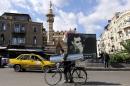 A billboard bears a portrait of President Bashar al-Assad in the Syrian capital of Damascus