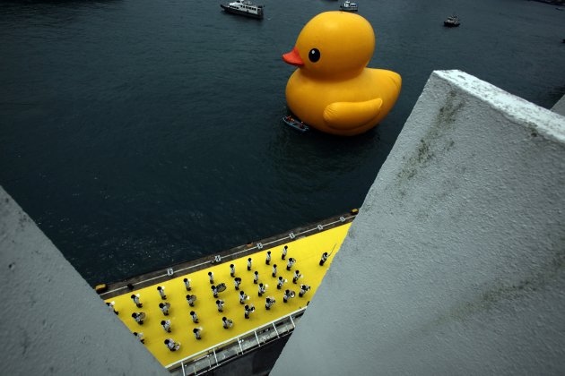 Police band performs as Rubber Duck by Dutch artist Hofman floats near Ocean Terminal at Hong Kong's Victoria Harbour