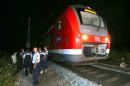 Police officers stand near a regional train in Wuerzburg, southern Germany, on July 18, 2016 after a man attacked train passengers with an axe