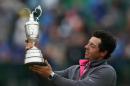 Rory McIlroy of Northern Ireland holds up the Claret Jug trophy after winning the British Open Golf championship at the Royal Liverpool golf club, Hoylake, England, Sunday July 20, 2014. (AP Photo/Scott Heppell)