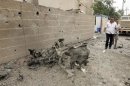 Iraqi security personnel inspect the site of a bomb attack in Kirkuk