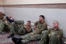 FILE PHOTO - An undated picture released by Iran's Revolutionary Guards website shows American sailors sit in an unknown place in Iran