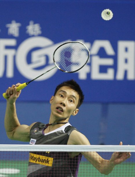 Lee of Malaysia hits a return against Tago of Japan in their men's singles match at the China Open badminton tournament in Shanghai