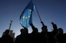 Protesters wave flags and shout slogans on Independence Square in Kiev