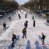 People skate on the frozen Keizersgracht canal in Amsterdam, Netherlands, Tuesday, Feb. 7, 2012. Volunteers poured onto frozen rivers and lakes in the northern Netherlands on Tuesday to shovel away snow that is one of the major hurdles in the way of a grueling speedskating race called Elfstedentocht, or 11 Cities Tour being held for the first time in 15 years. (AP Photo/Margriet Faber)
