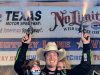 Sprint Cup Series's Kyle Busch (18) celebrates by firing six shooters after winning the NASCAR Sprint Cup series NRA 500 auto race at Texas Motor Speedway  Saturday, April 13, 2013, in Fort Worth, Texas. (AP Photo/Larry Papke)