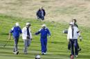 US team captain Tom Watson, second left, congratulates Europe's Jamie Donaldson, left, and captain Paul McGinley, center, after winning the Ryder Cup golf tournament during the singles match on the final day of the at Gleneagles, Scotland, Sunday, Sept. 28, 2014. (AP Photo/Alastair Grant)