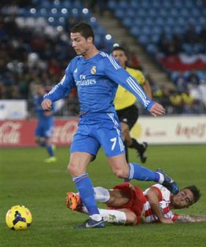Real Madrid's Ronaldo is challenged by Almeria's Fernandez …