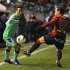 Barcelona's Thiago Alcantara fights for ball with Osasuna's Juan Fernandez Martinez "Nino" during their Spanish First Division soccer match in Pamplona