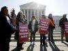 Leonida Martinez, left, from Phoenix, Ariz., and others, take part in a demonstration in front of the Supreme Court in Washington, Wednesday, April 25, 2012, as the court questions Arizona's "show me your papers" immigration law . (AP Photo/Charles Dharapak)