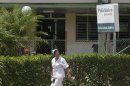 Nurse walks outside Cristobal Labra health clinic, where according to local media, victims of an alcohol poisoning incident were first treated in Havana