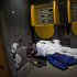 In this Friday, Feb. 10, 2012 photo a homeless men sleep inside a ATM machine in Barcelona, Spain.  Spain's phenomenal real estate crash and economic implosion has turned what was supposed to become a vibrant suburban paradise for young Spanish couples and their children into one of the most visible monuments of the country's real estate boom gone bust. (AP Photo/Emilio Morenatti)