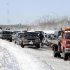 Traffic is backed up on the Long Island Expressway just west of Exit 59 Ocean Avenue as payloaders clear snow from the road after a storm, Saturday, Feb. 9, 2013, in Ronkonkoma , N.Y. (AP Photo/Kathy Kmonicek)