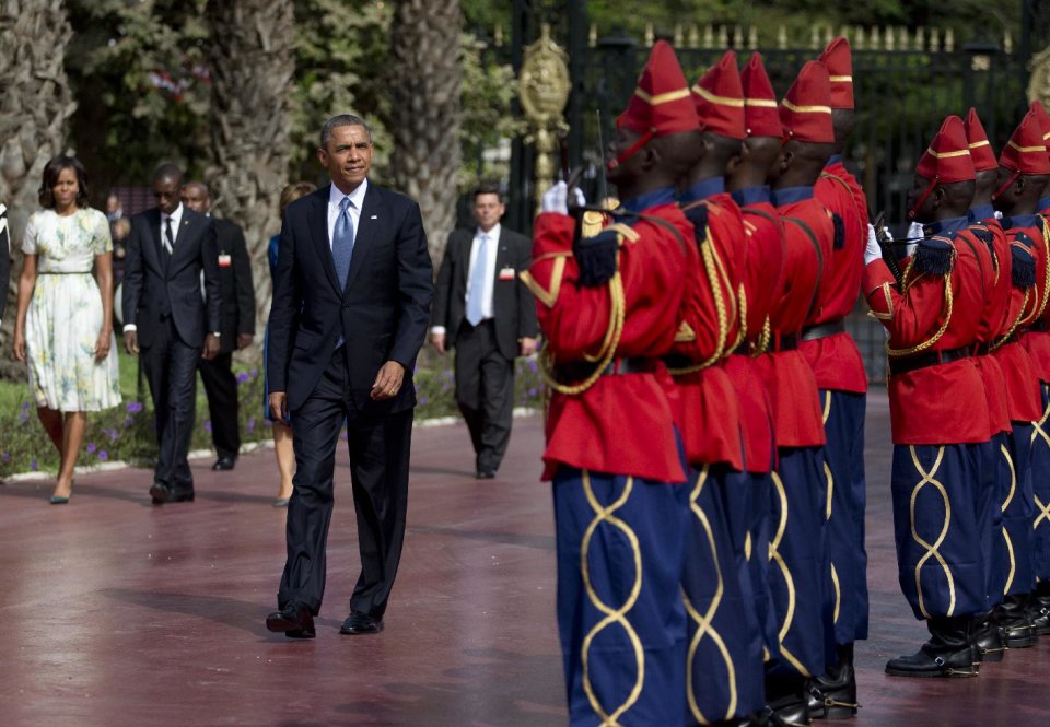 U.S. President Barack Obama is welcomed by a Senegalese honor guard as he arrives at the presidential palace in Dakar, Senegal, Thursday, June 27, 2013. President Obama landed in Senegal Wednesday night to kick off a weeklong trip to Africa, a three-country visit aimed at overcoming disappointment on the continent over the first black U.S. president's lack of personal engagement during his first term. (AP Photo/Carolyn Kaster)