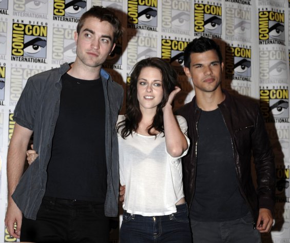 In this July 21, 2011 photo, from left, Robert Pattinson, Kristen Stewart and Taylor Lautner pose at an event held to promote the film "The Twilight Saga: Breaking the Dawn Part 1" at the Comic-Con International 2011 convention July 21, 2011, in San Diego. The latest "Twilight" movie still cast the longest shadow with $16.9 million for a third-straight No. 1 finish during one of the year's slowest weekends at the box office. Business was dismal, with box-office tracker Hollywood.com estimating Sunday that domestic revenues totaled just $82 million. (AP Photo/Denis Poroy)