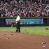 Atlanta Braves officials pick up trash on the field as security stand by during the eighth inning of the National League wild card playoff baseball game against the St. Louis Cardinals, Friday, Oct. 5, 2012, in Atlanta. The Cardinals won baseball's first wild-card playoff, taking advantage of a disputed infield fly call that led to a protest and fans littering the field with debris to defeat the Braves 6-3. (AP Photo/Todd Kirkland)