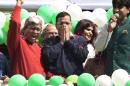 FILE - In this Tuesday, Feb. 10, 2015 file photo, Aam Aadmi Party, or Common Man's Party leader Arvind Kejriwal, center, coughs while the party's senior leader Ashutosh, left, and others shout slogans to celebrate the party's election performance in New Delhi, India. Kejriwal, the former tax official with the chronic cough and the ill-fitting sweaters, the man who had remade himself into a champion for clean government, seemed lost in the political wilderness. The crusading politician was suddenly a punchline. But on Wednesday, Feb. 11, there was Kejriwal on the front page of nearly every Indian newspaper, celebrating election results that again make him New Delhi's chief minister. Kejriwal and the party he created routed the country's best-funded and best-organized political machine and dealt an embarrassing blow to Prime Minister Narendra Modi. (AP Photo/Manish Swarup, File)