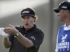 Phil Mickelson, left, talks with his caddie Jim Mackay during the second round of the Farmers Insurance Open golf tournament, Friday, Jan. 27, 2012 in San Diego . (AP Photo/Gregory Bull)