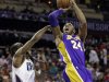Los Angeles Lakers' Kobe Bryant, right, shoots over Charlotte Bobcats' Kemba Walker, left, during the second half of an NBA basketball game in Charlotte, N.C., Friday, Feb. 8, 2013. The Lakers won 100-93. (AP Photo/Chuck Burton)