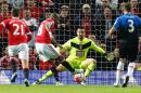 Manchester United's midfielder Ashley Young (2L) shoots towards Bournemouth's goalkeeper Adam Federici (C) to score his team's thrid goal during the rescheduled English Premier League football match in Manchester, England, on May 17, 2016