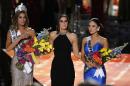 Former Miss Universe Paulina Vega, center, reacts before taking away the flowers, crown and sash from Miss Colombia Ariadna Gutierrez, left, before giving it to Miss Philippines Pia Alonzo Wurtzbach at the Miss Universe pageant Sunday, Dec. 20, 2015, in Las Vegas. Gutierrez was incorrectly named Miss Universe. (AP Photo/John Locher)